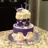 This Suprise Birthday Cake was for a 17 Year Old Young Lady.  It is a Butter-Vanilla Cake.  The First Layer of Filling is Buttercream.  The Second Layer of Filling is Chocolate Mouse.  The Frosting is Purple Buttercream.  The Decorations are Fondant. 